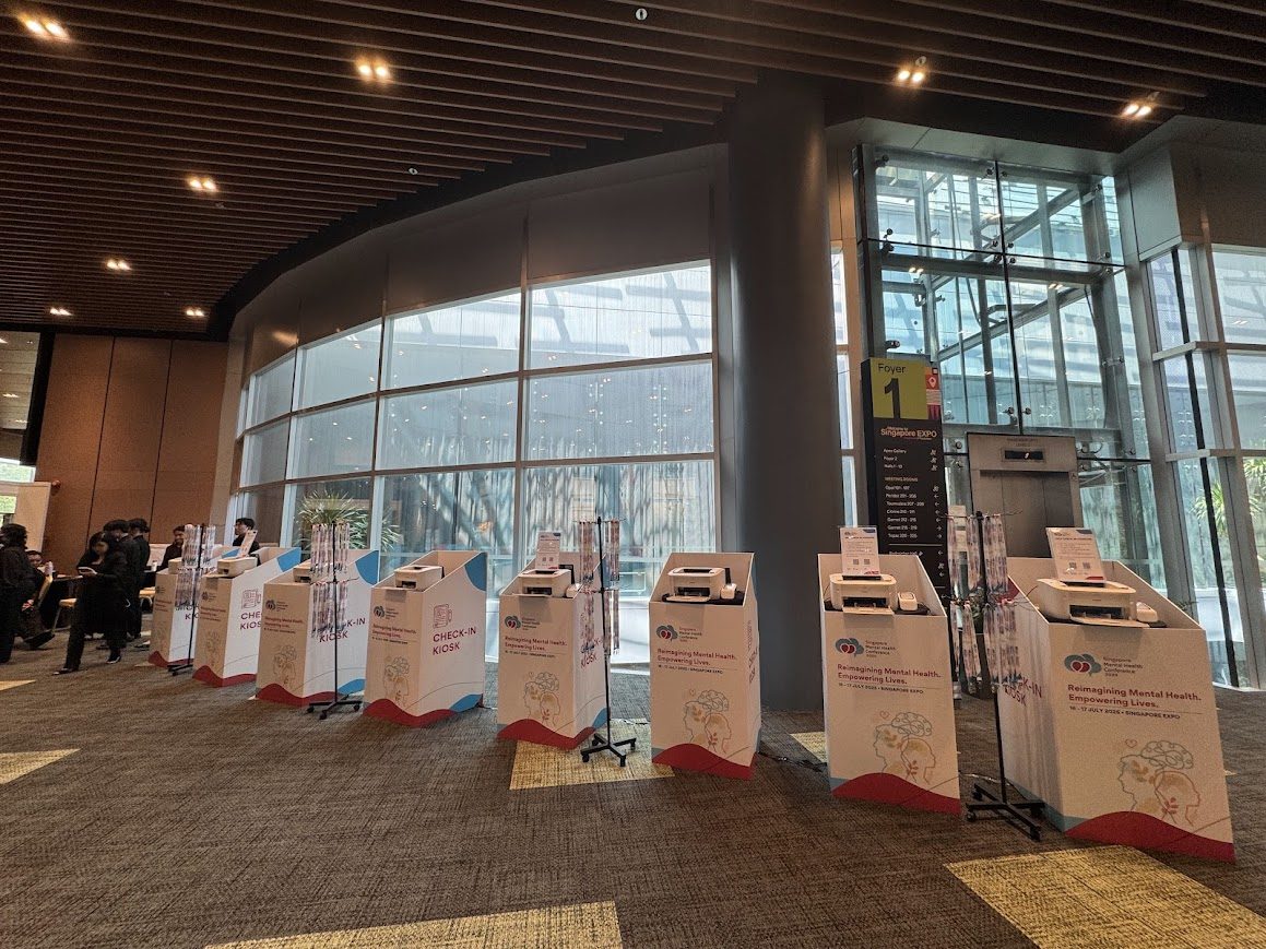 Self-service event registration kiosks with QR codes and badge printers