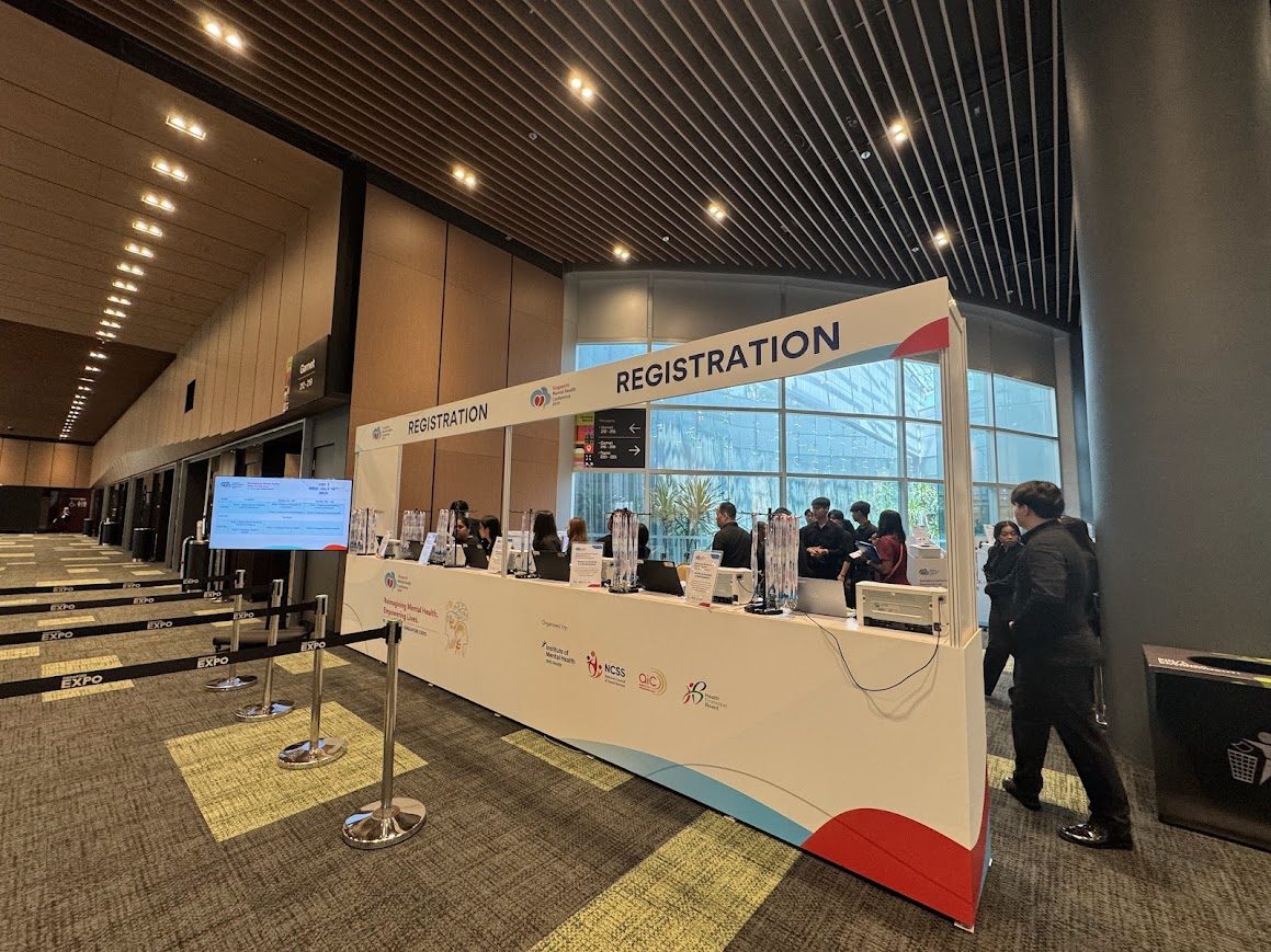 Large event registration booth with QR check-in counters and queue management